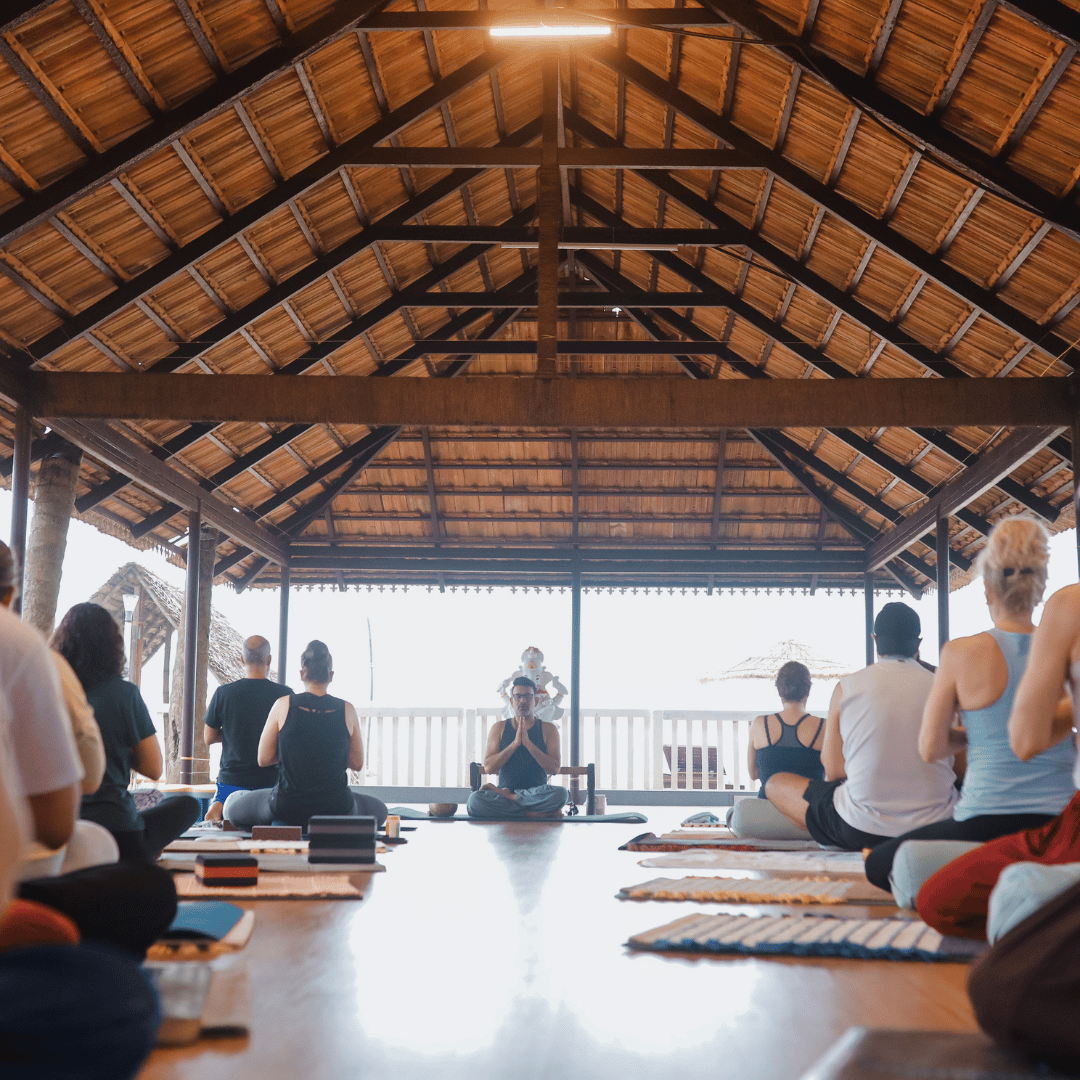 Yoga group meditating at sunrise on a previous Himalayan retreat